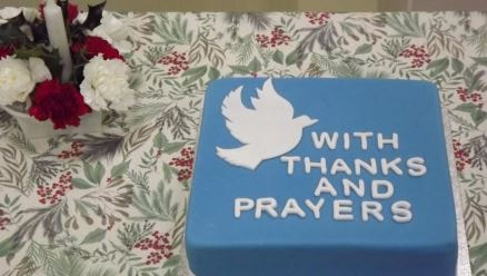 An iced birthday cake inscribed With Thanks and Prayers